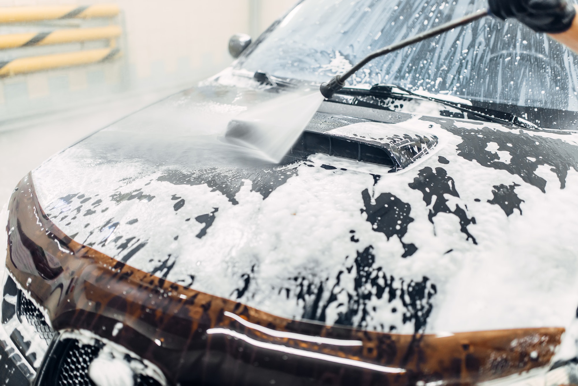 Carwash service, car cleaning, top view on hood